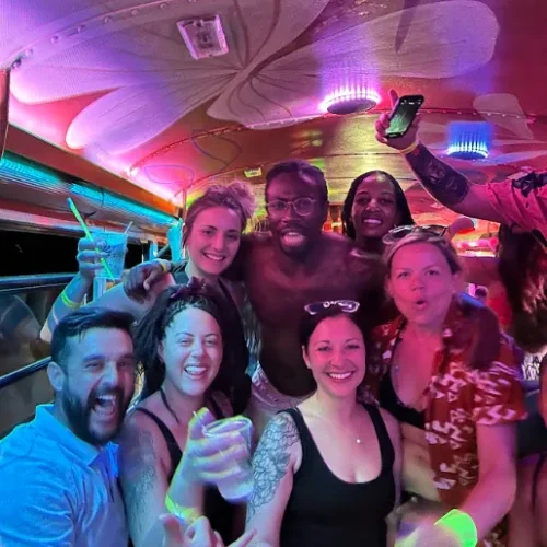 Birthday group celebrating under the lights on the Tamarindo party bus