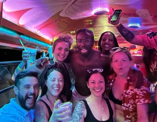 Birthday group celebrating under the lights on the Tamarindo party bus