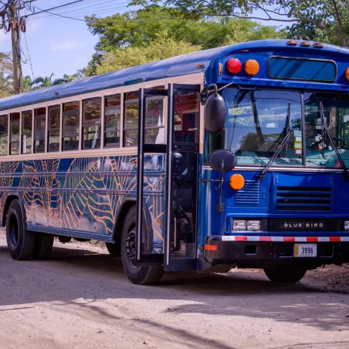The Crawler Hauler, a blue Blue Bird party bus, parked in Tamarindo, Costa Rica