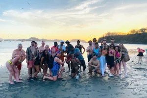 Beach and pool crawl group at sunset on Playa Potrero near Las Brisas, Guanacaste, Costa Rica